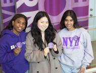 Students pose to support NYU One Day