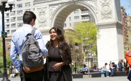 Students chat in front of the arch at Washington Square Park
